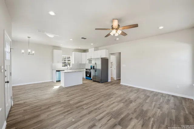 a kitchen with kitchen island a sink stove and refrigerator