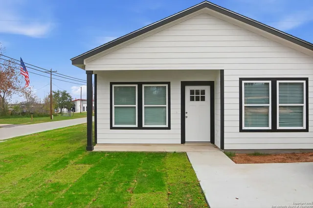 a front view of a house with a yard