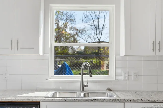 a stove top oven sitting inside of a kitchen