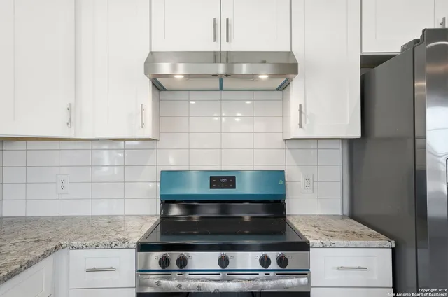 a kitchen with a stove a sink and a refrigerator