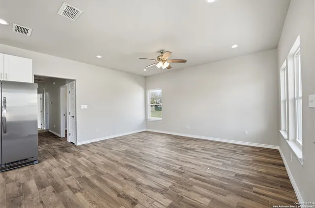 wooden floor in an empty room with a window