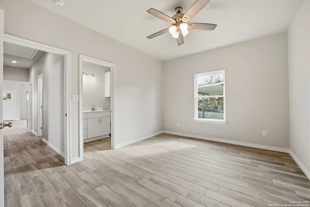 a bathroom with a toilet sink vanity shower and mirror