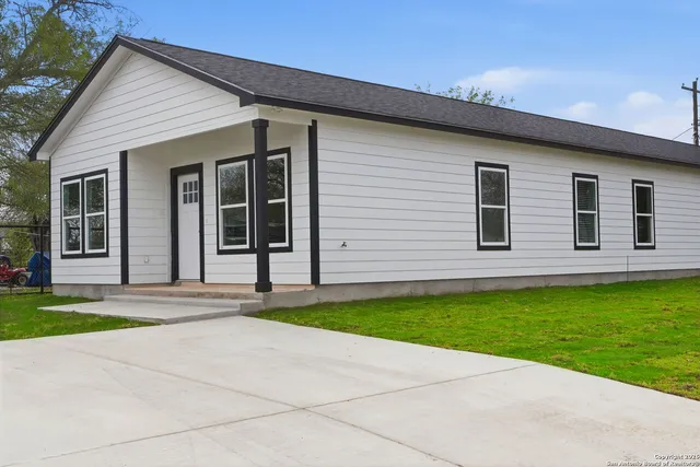 a back view of a house with a yard