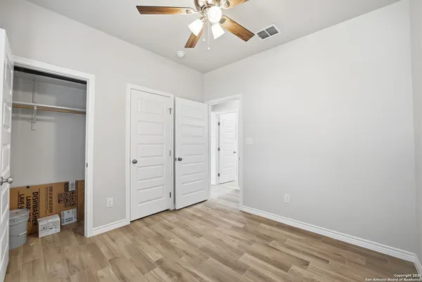 a view of staircase with wooden floor and white walls
