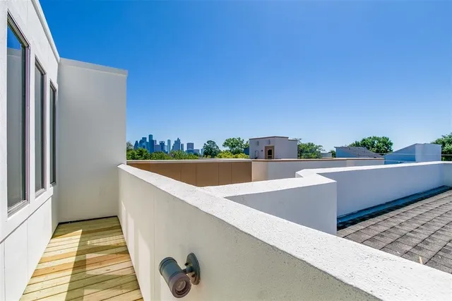 a view of roof deck with chair and wooden floor