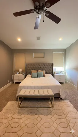 a bedroom with a bed and ceiling fan