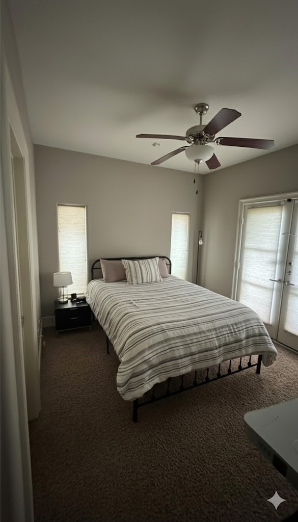 1408 Vermont Street, Unit C Houston, TX 77006 - Photo 22 of 23 a bedroom with a bed and a chandelier
