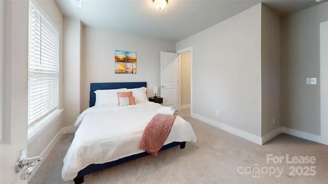 a bedroom with a bed and window