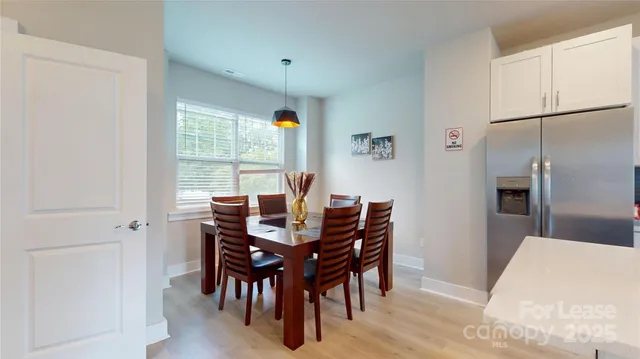 a view of a dining room with furniture and window