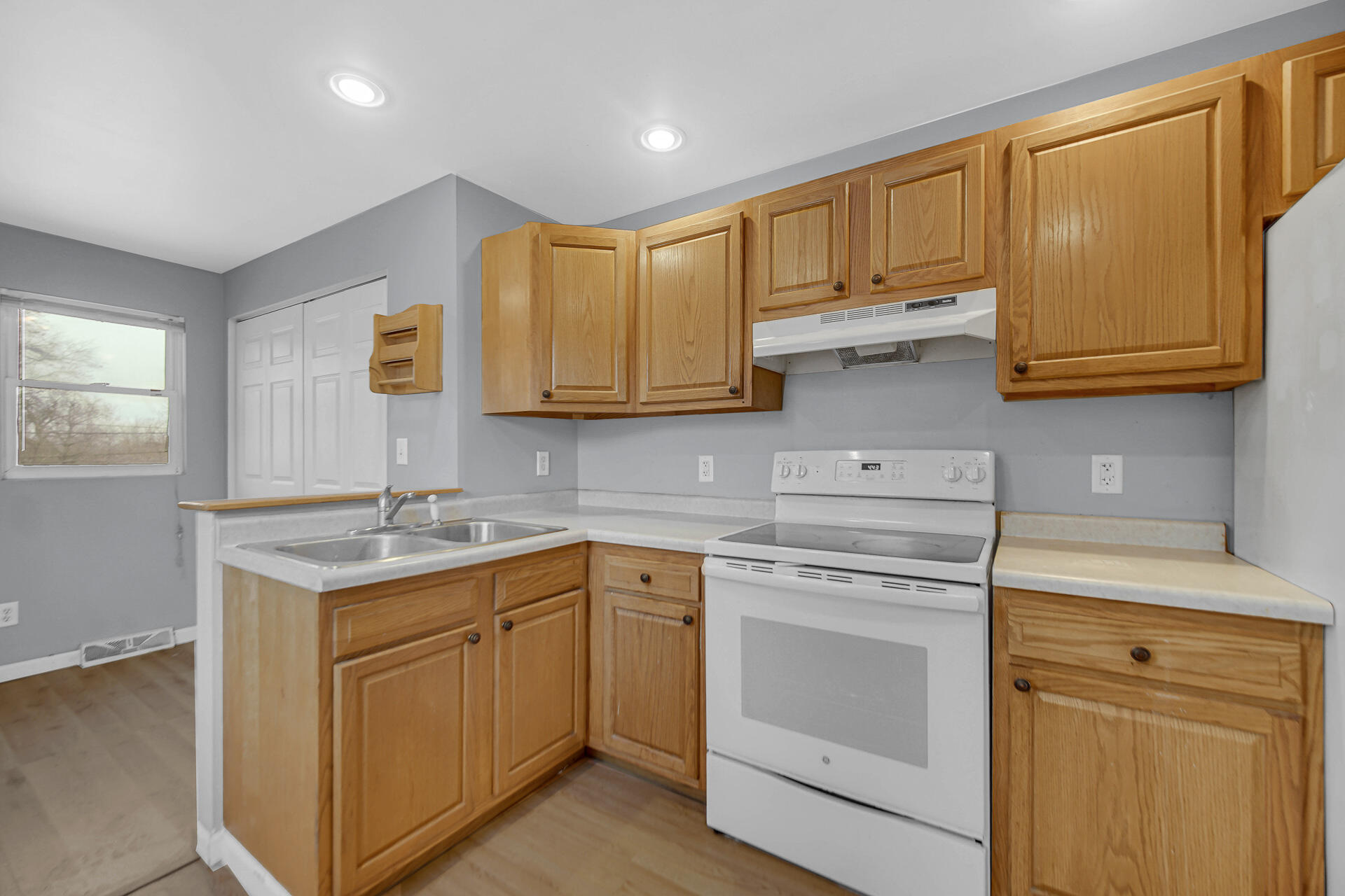 2228 Riverside Drive Lake Station, IN 46405 - Photo 12 of 22 a kitchen with stainless steel appliances granite countertop a sink stove and cabinets