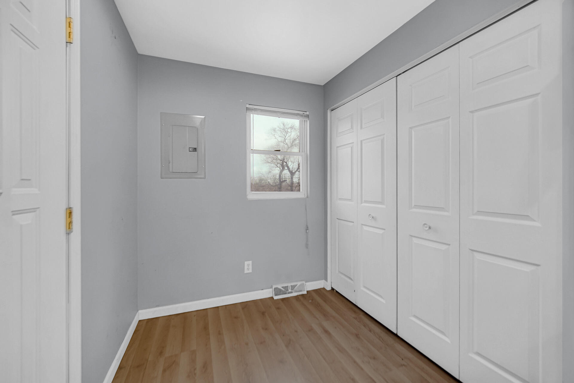 2228 Riverside Drive Lake Station, IN 46405 - Photo 14 of 22 a view of an empty room with wooden floor and a window