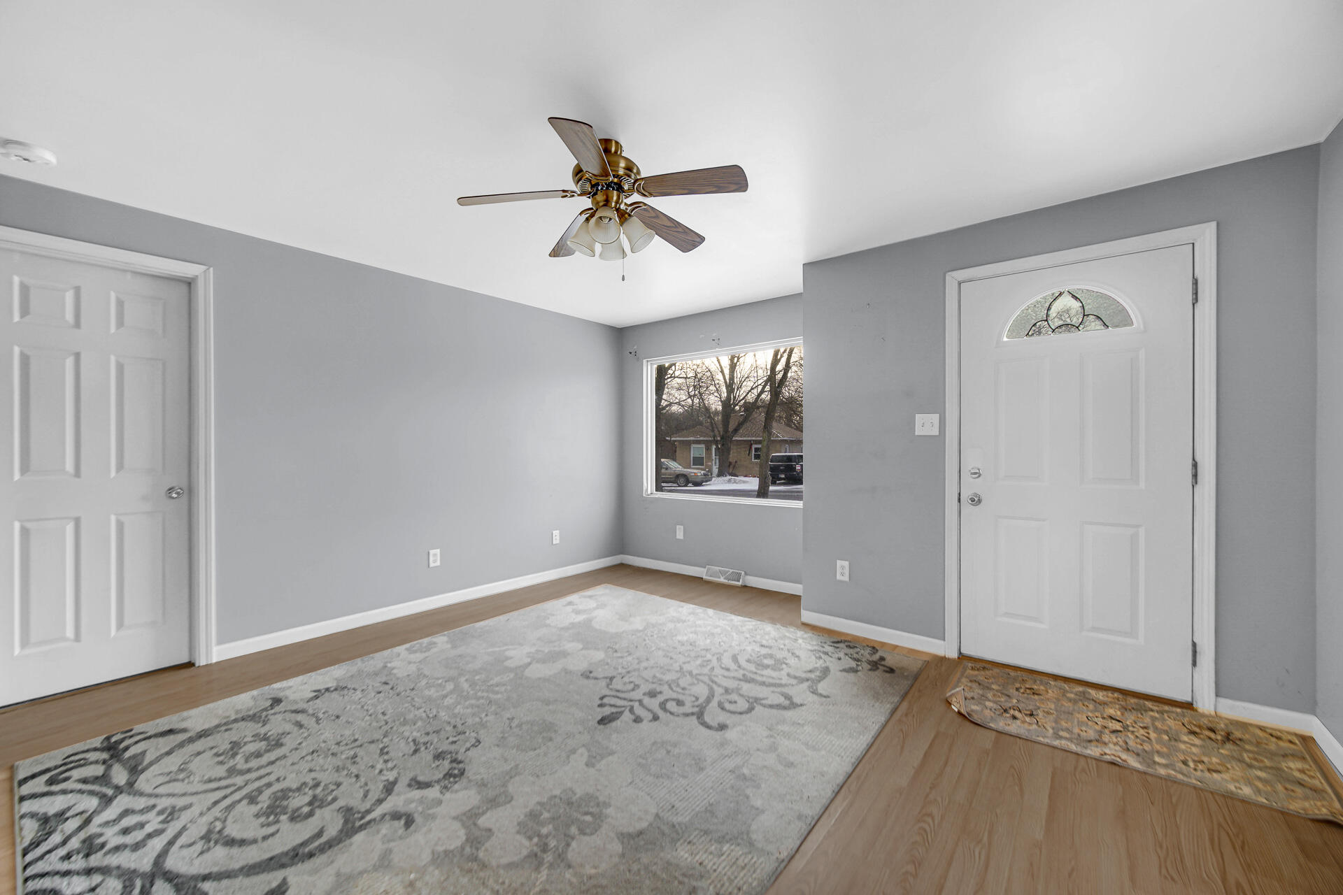 2228 Riverside Drive Lake Station, IN 46405 - Photo 9 of 22 a view of a big room with wooden floor and chandelier fan