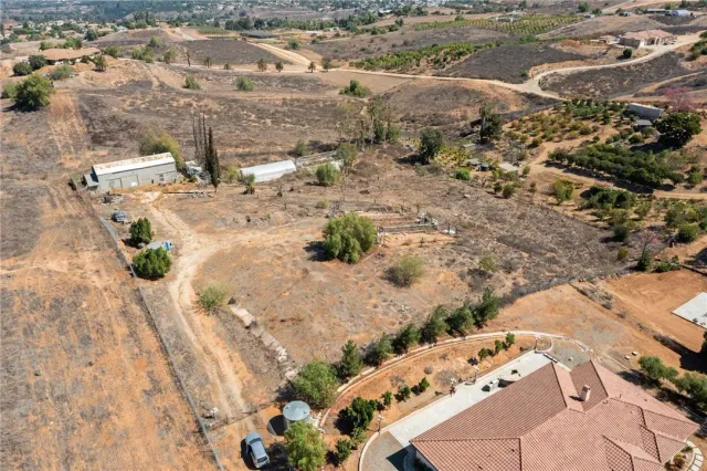 an aerial view of a house with a yard