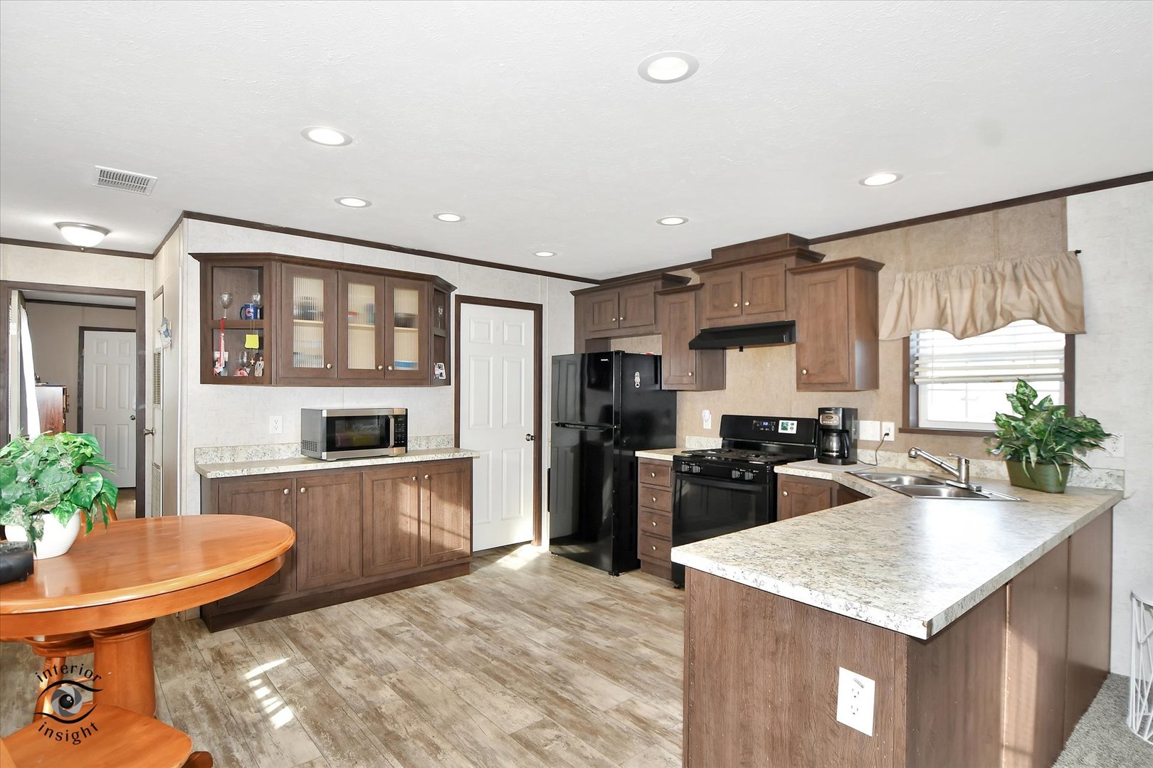 72 Apple Lane Bourbonnais, IL 60914 - Photo 8 of 23 a kitchen with sink refrigerator dining table and chairs