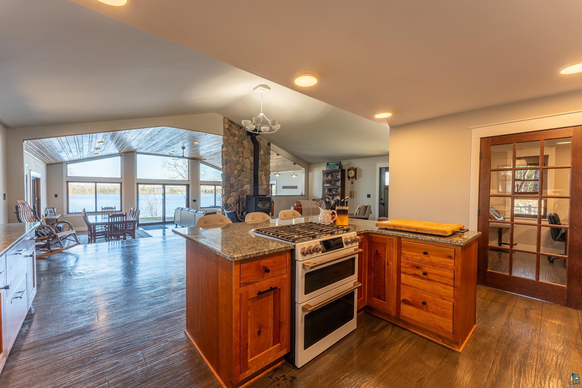 14635 Canadian Border Road Ely, MN 55731 - Photo 51 of 94 Kitchen island with granite countertop, wood cabinetry, and a double-oven range
