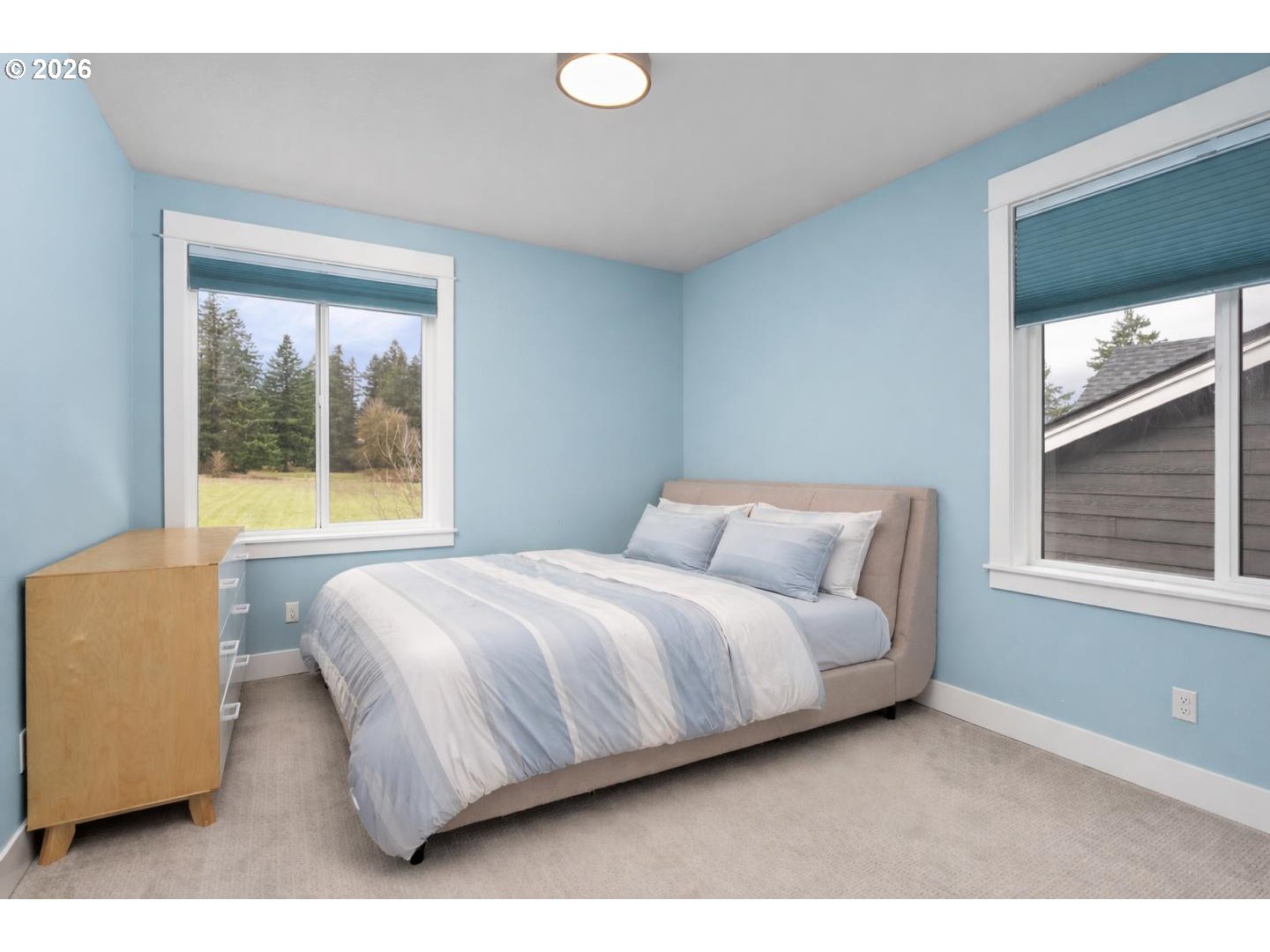 4010 Northwest 62nd Circle Camas, WA 98607 - Photo 23 of 46 a bedroom with a bed lamp and a large window