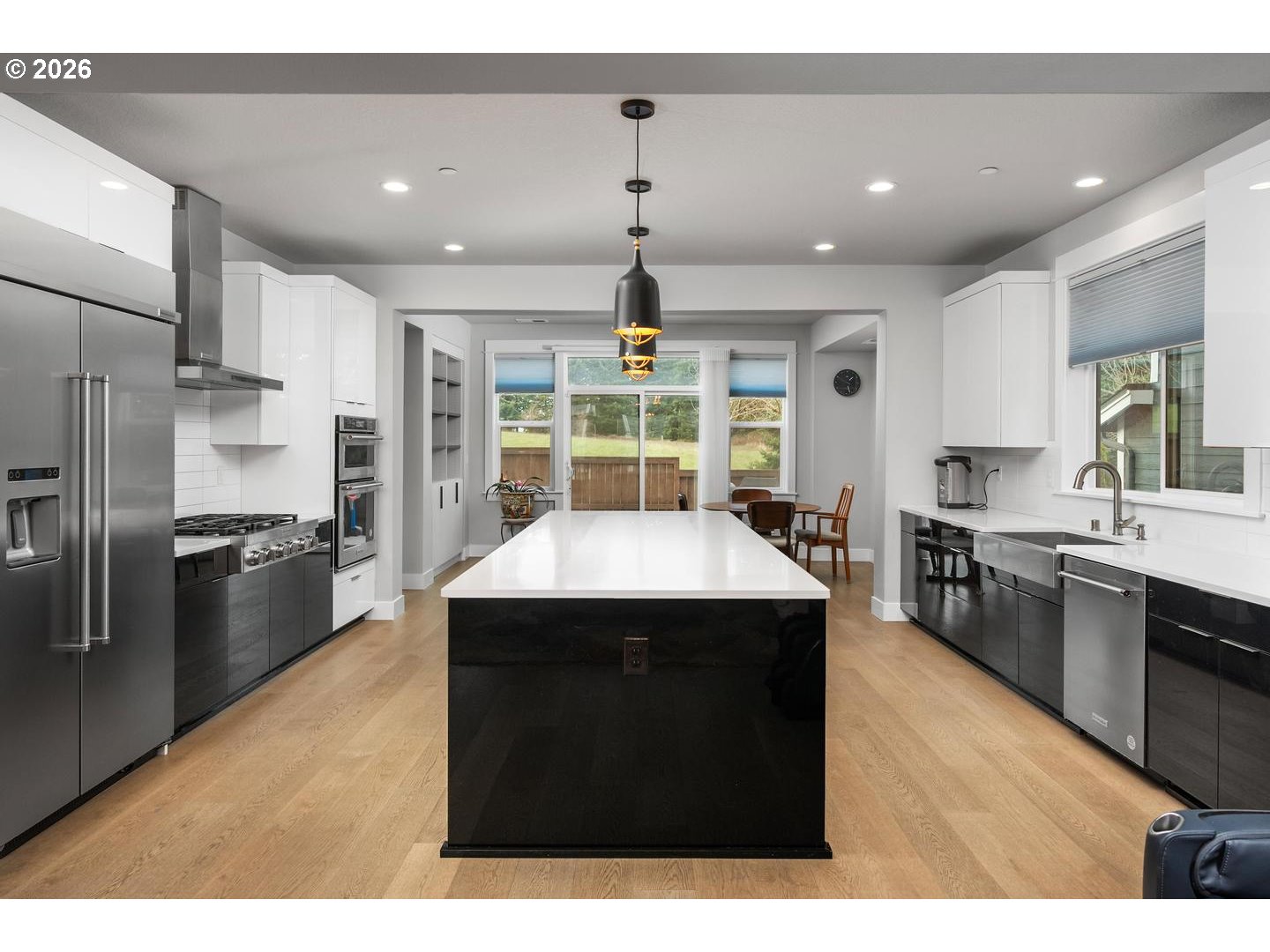 4010 Northwest 62nd Circle Camas, WA 98607 - Photo 7 of 46 a kitchen with kitchen island stainless steel appliances a sink stove and refrigerator