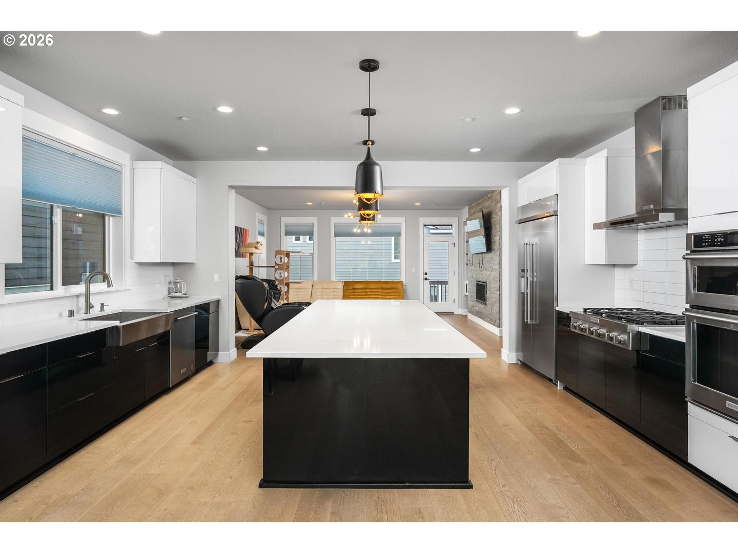 4010 Northwest 62nd Circle Camas, WA 98607 - Photo 9 of 46 a large kitchen with kitchen island a stove a sink dishwasher and a black countertops with wooden floor