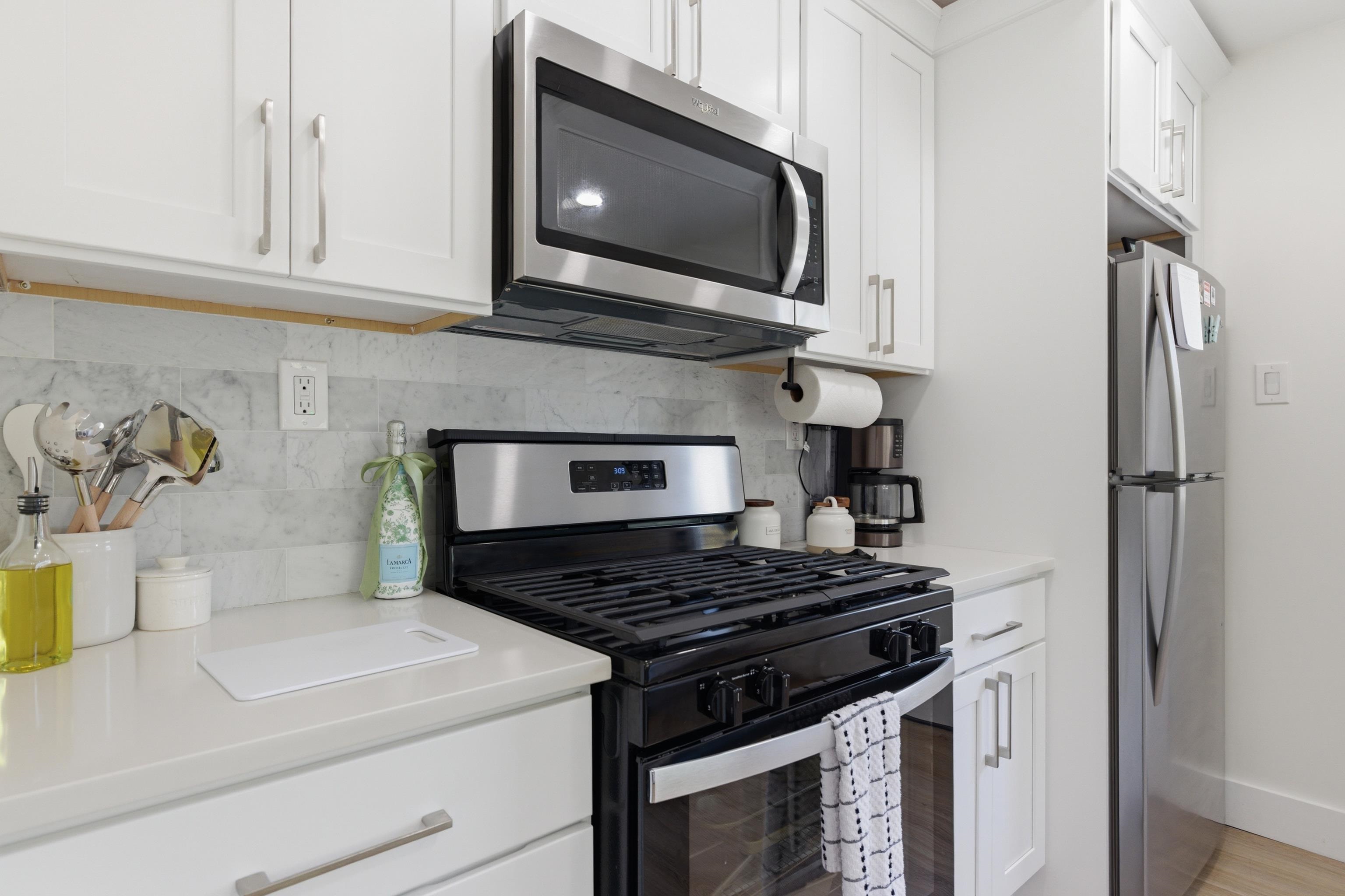 209 Breakwater Road North Cape May, NJ 08204 - Photo 12 of 40 a kitchen with stainless steel appliances granite countertop a stove and a microwave