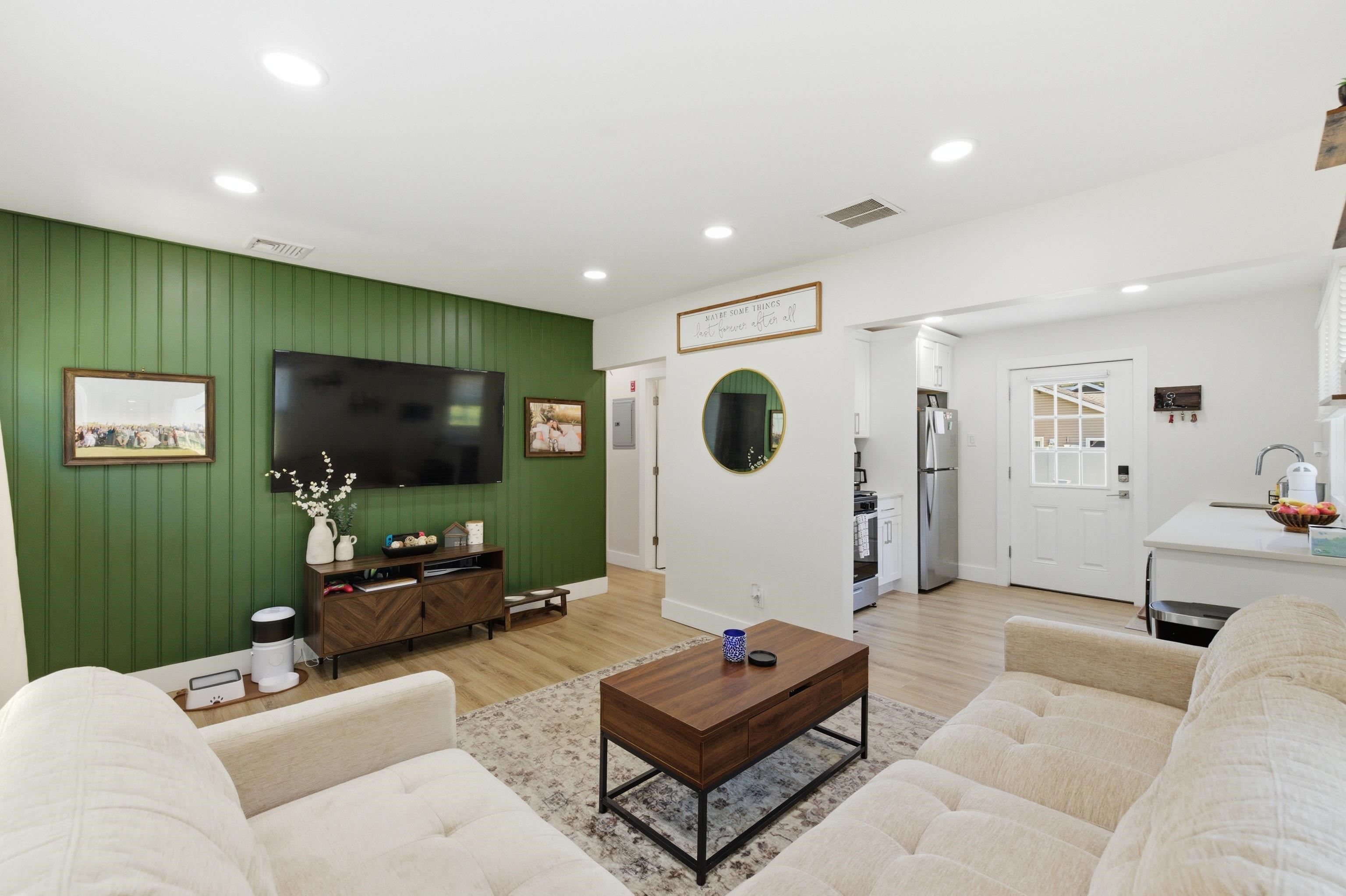 209 Breakwater Road North Cape May, NJ 08204 - Photo 14 of 40 a living room with furniture and a flat screen tv