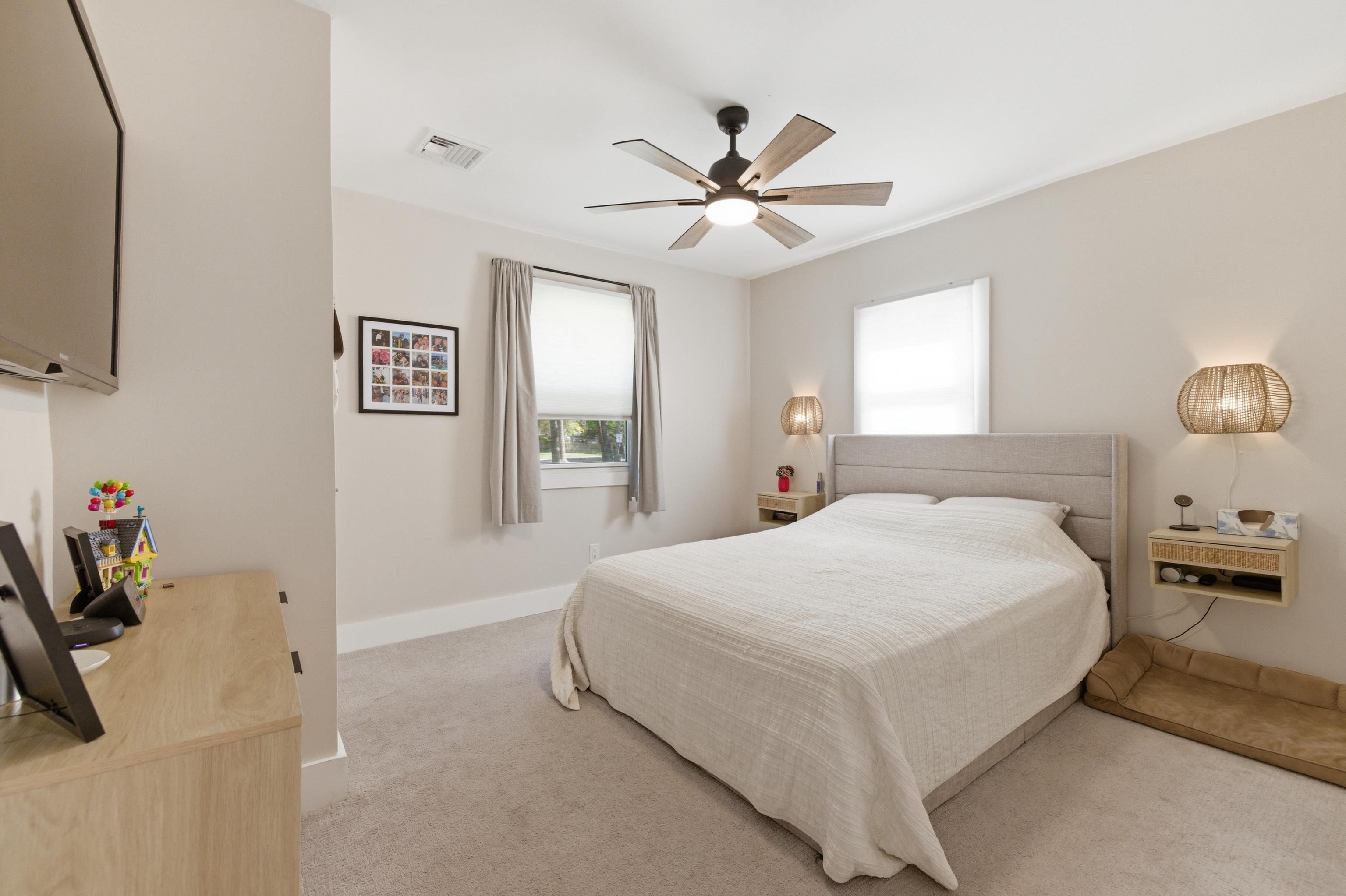 209 Breakwater Road North Cape May, NJ 08204 - Photo 18 of 40 a bedroom with a bed and a chandelier