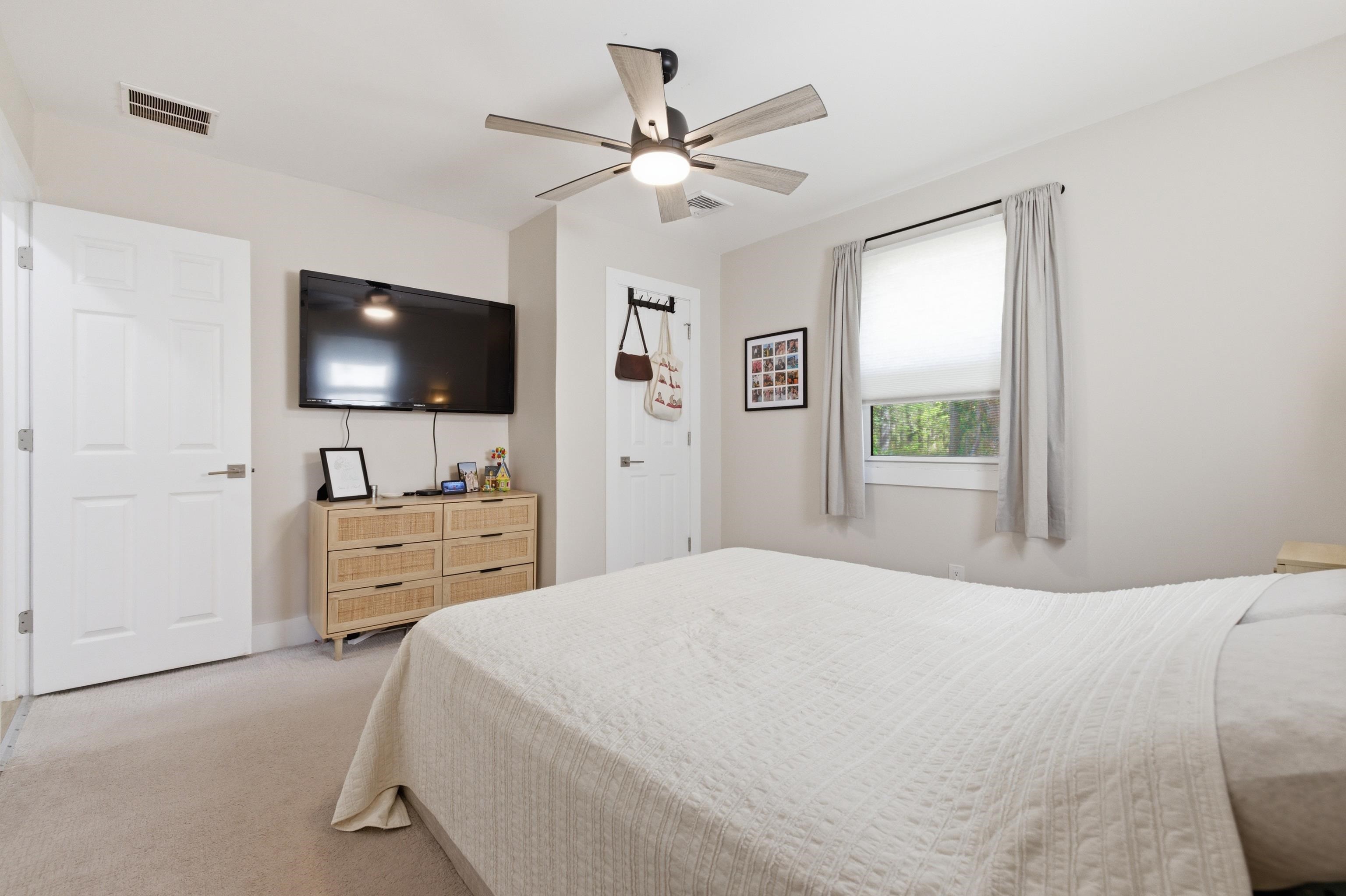 209 Breakwater Road North Cape May, NJ 08204 - Photo 19 of 40 a bedroom with a bed and a flat screen tv