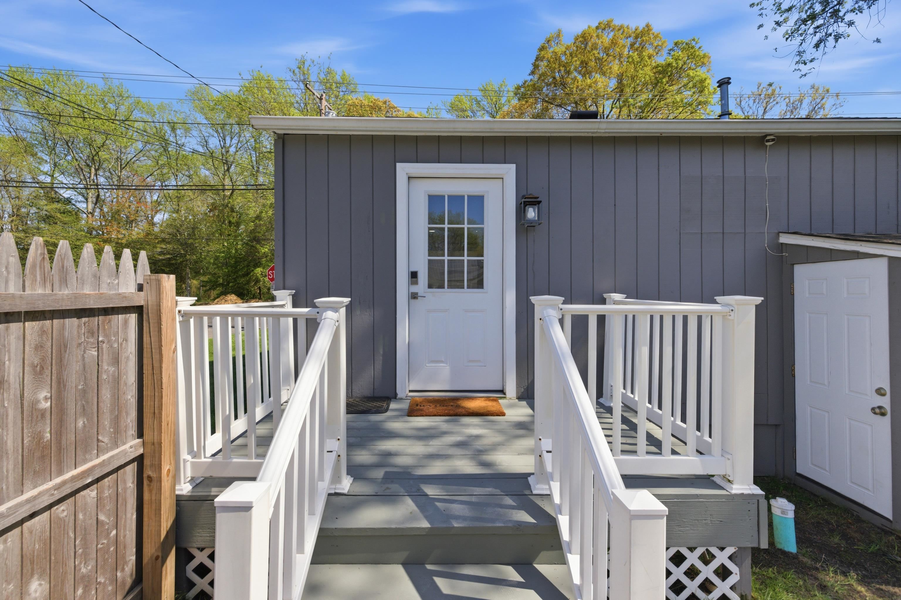 209 Breakwater Road North Cape May, NJ 08204 - Photo 4 of 40 a view of a balcony with wooden floor and fence