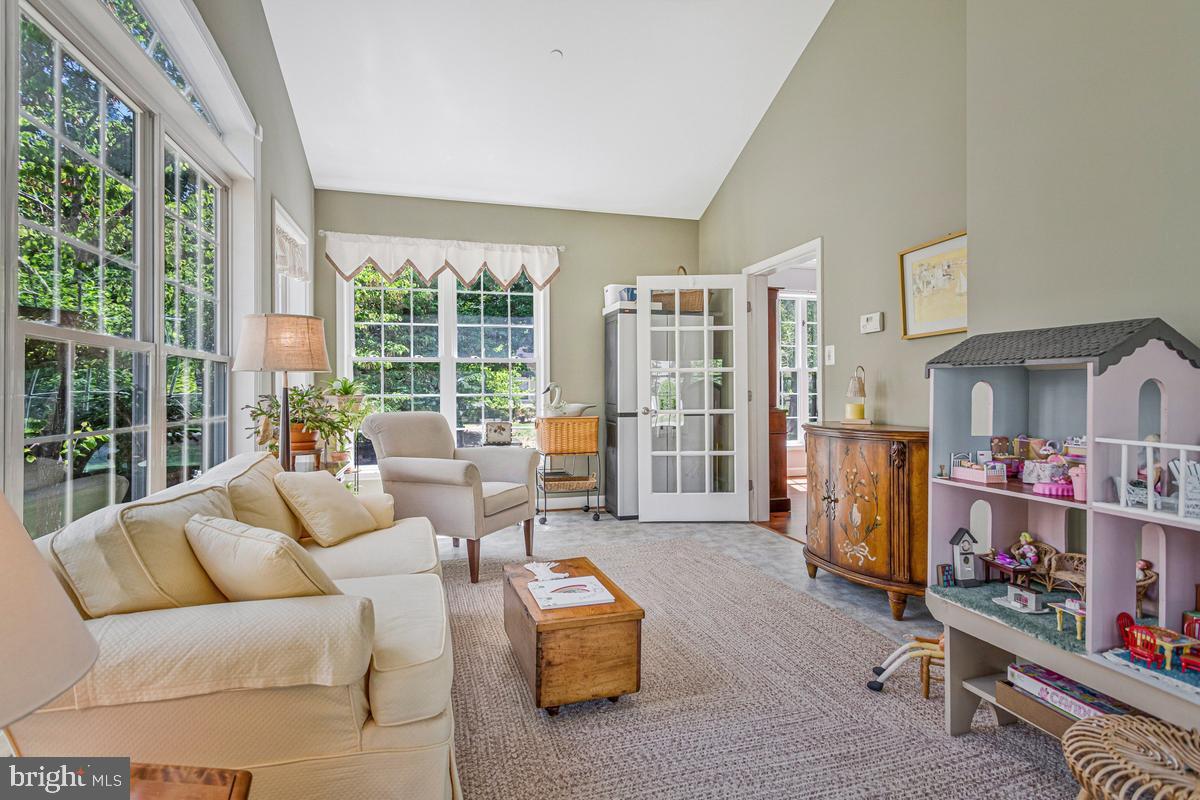 11565 Magnolia Court Issue, MD 20645 - Photo 13 of 68 a living room with furniture and a floor to ceiling window