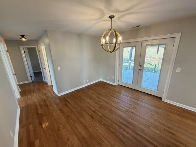 a kitchen with stainless steel appliances a refrigerator a sink a stove a microwave and cabinets