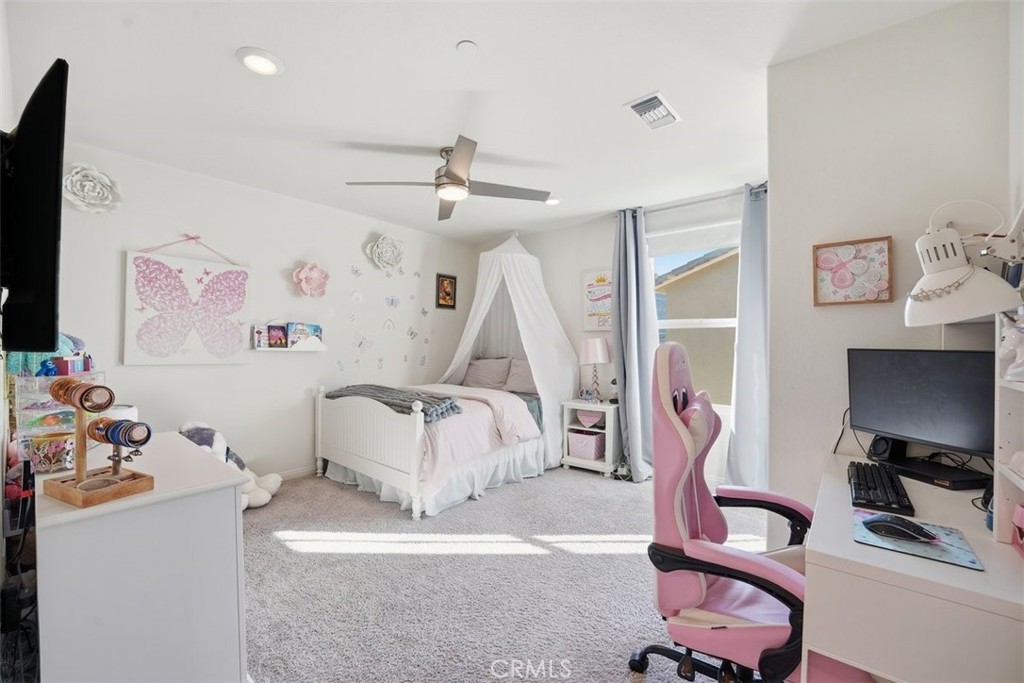 7608 Citrusmoon Court Riverside, CA 92507 - Photo 15 of 25 a bedroom with furniture a flat screen tv and a couch