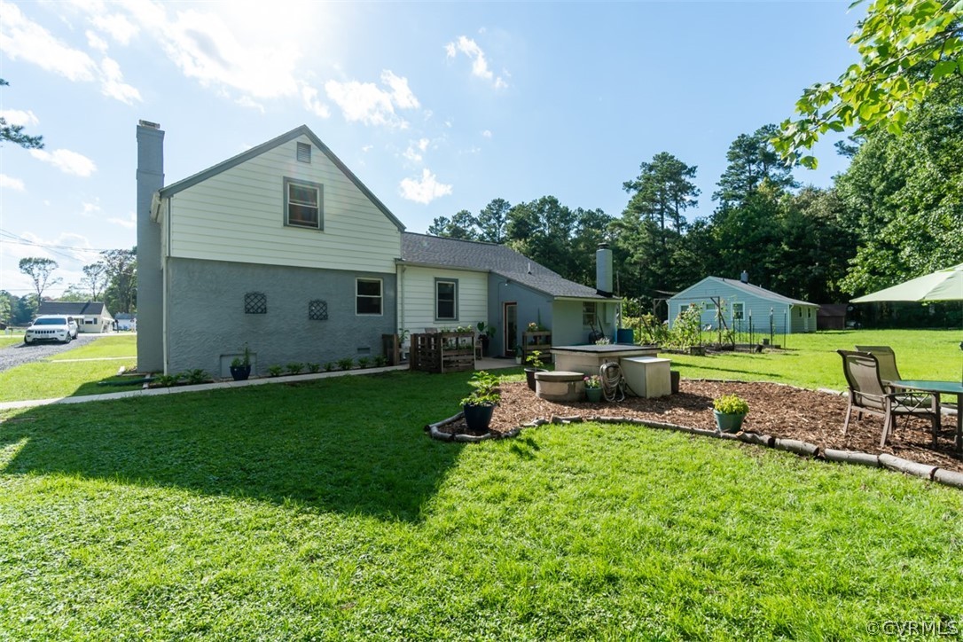 8255 Varina Road Henrico, VA 23231 - Photo 26 of 30 a view of a house with backyard sitting area and garden