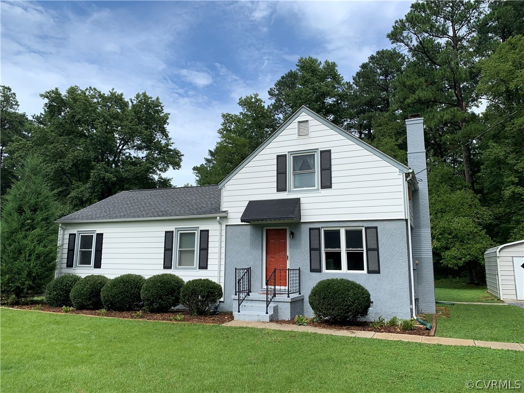 8255 Varina Road Henrico, VA 23231 - Photo 4 of 30 a front view of a house with a yard and green space
