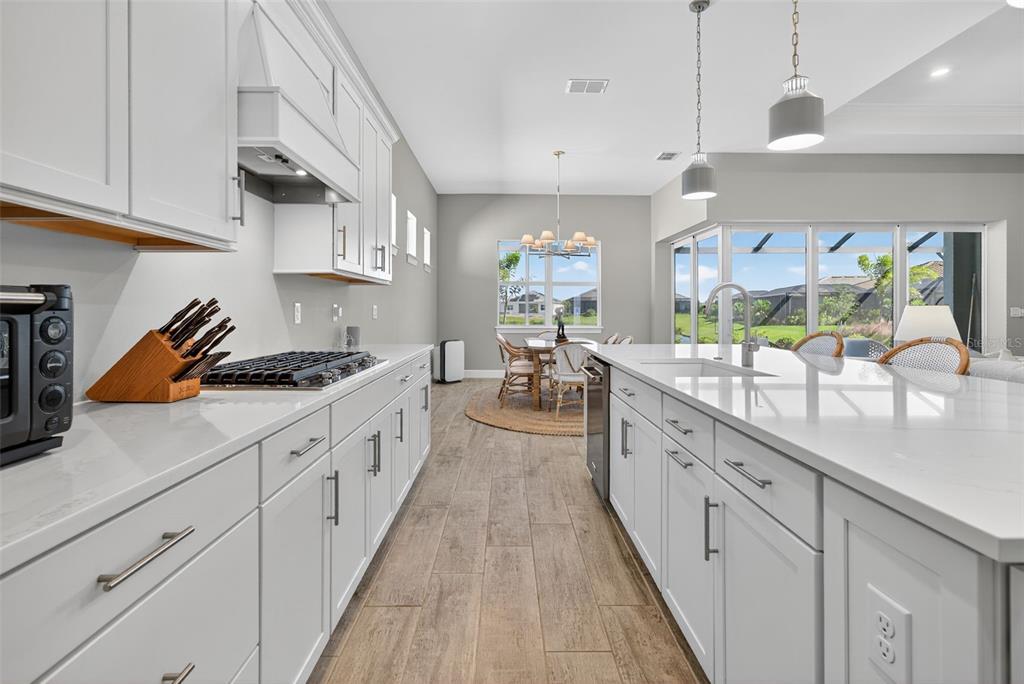 26532 Key Sands Street Englewood, FL 34223 - Photo 20 of 97 a large kitchen with stainless steel appliances lots of counter space and a sink