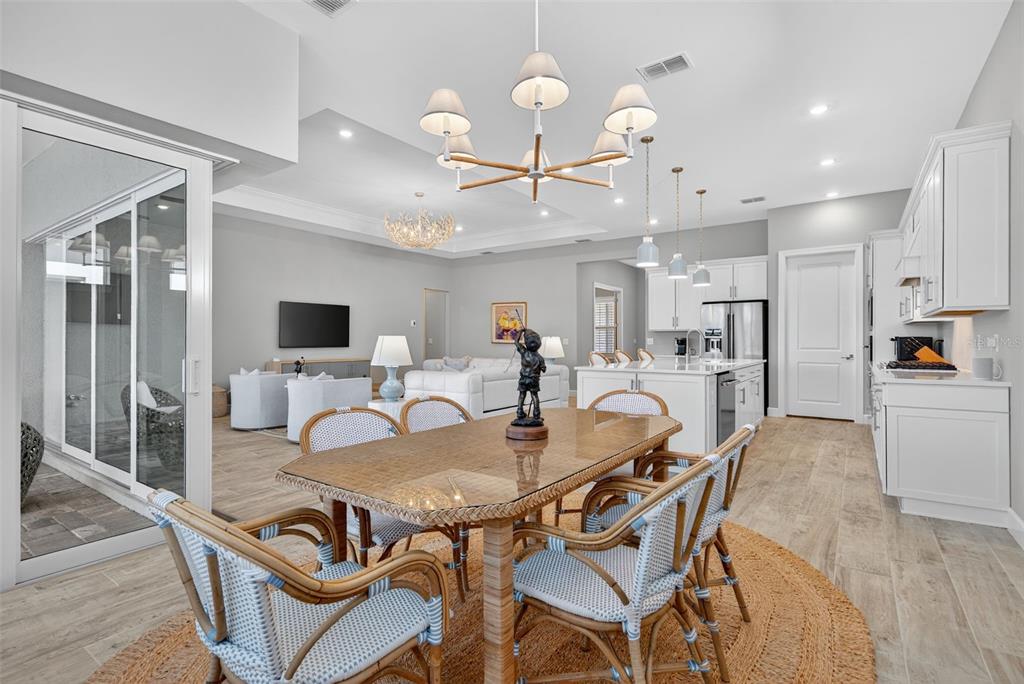 26532 Key Sands Street Englewood, FL 34223 - Photo 25 of 97 a dining room with furniture and wooden floor