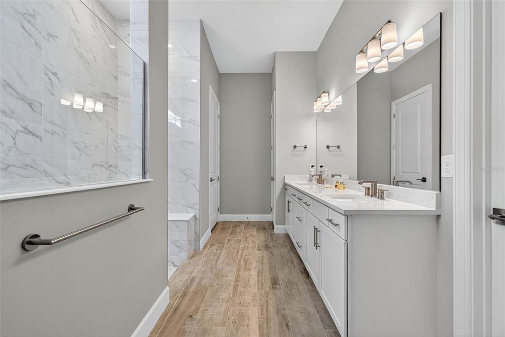 26532 Key Sands Street Englewood, FL 34223 - Photo 37 of 97 a spacious bathroom with a double vanity sink and a mirror