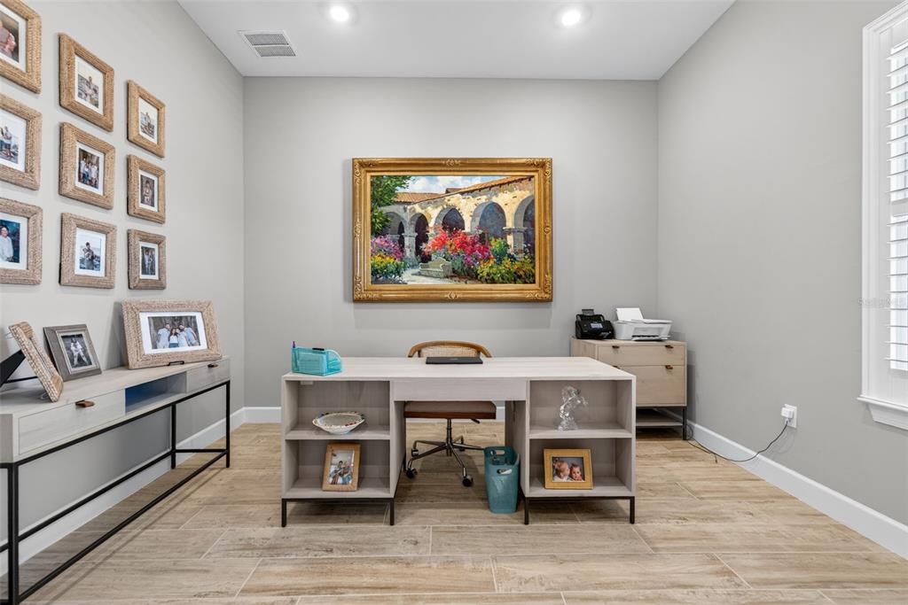 26532 Key Sands Street Englewood, FL 34223 - Photo 44 of 97 a living room with furniture and paintings on the wall