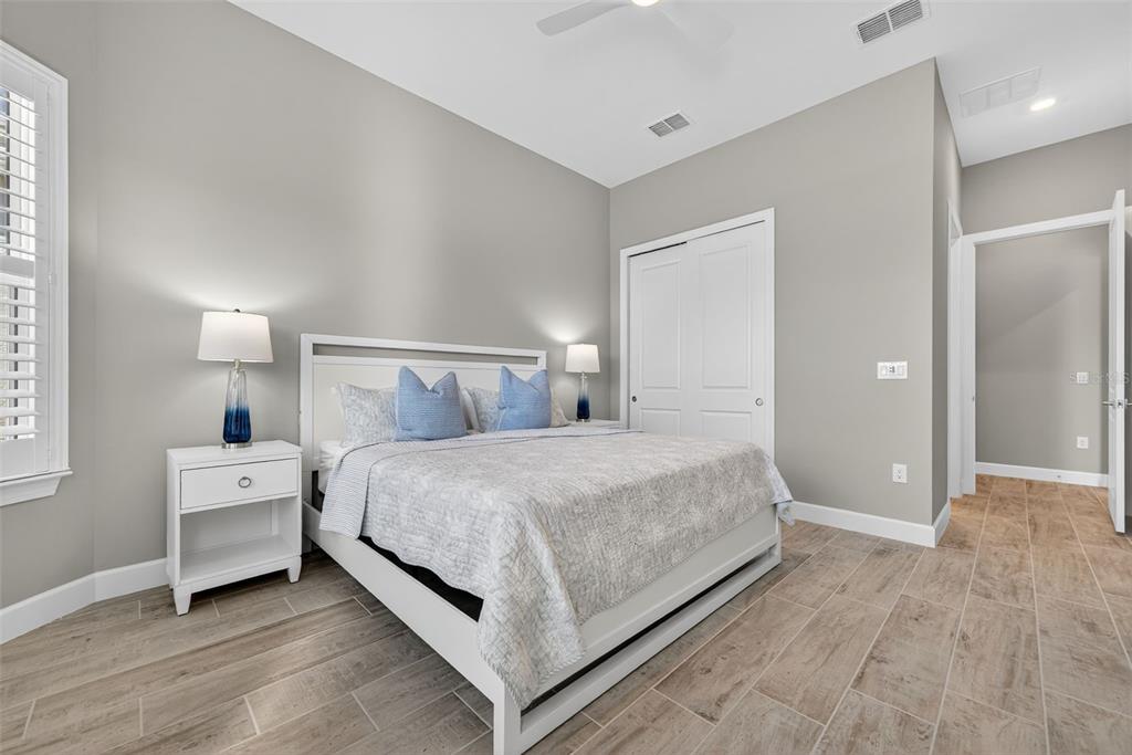 26532 Key Sands Street Englewood, FL 34223 - Photo 50 of 97 a bed room with a bed and a night stand