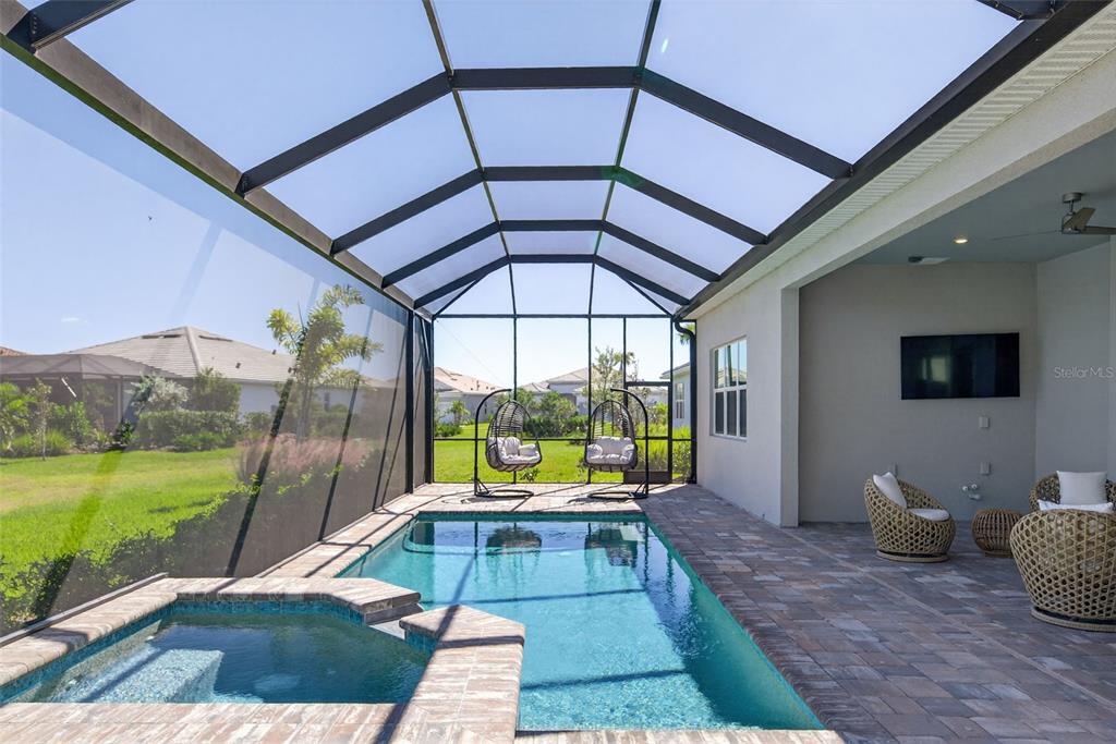 26532 Key Sands Street Englewood, FL 34223 - Photo 70 of 97 a view of swimming pool with a lounge chairs in front of house