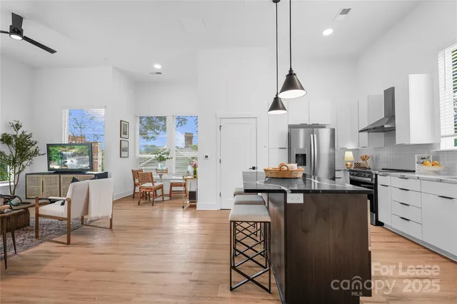 a kitchen with granite countertop a sink appliances and cabinets