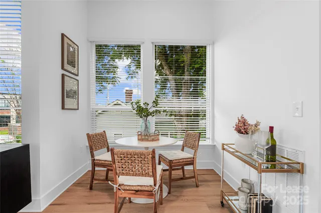 a dining room with furniture and a potted plant