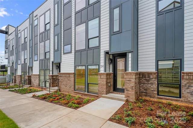 a swimming pool with outdoor seating and yard