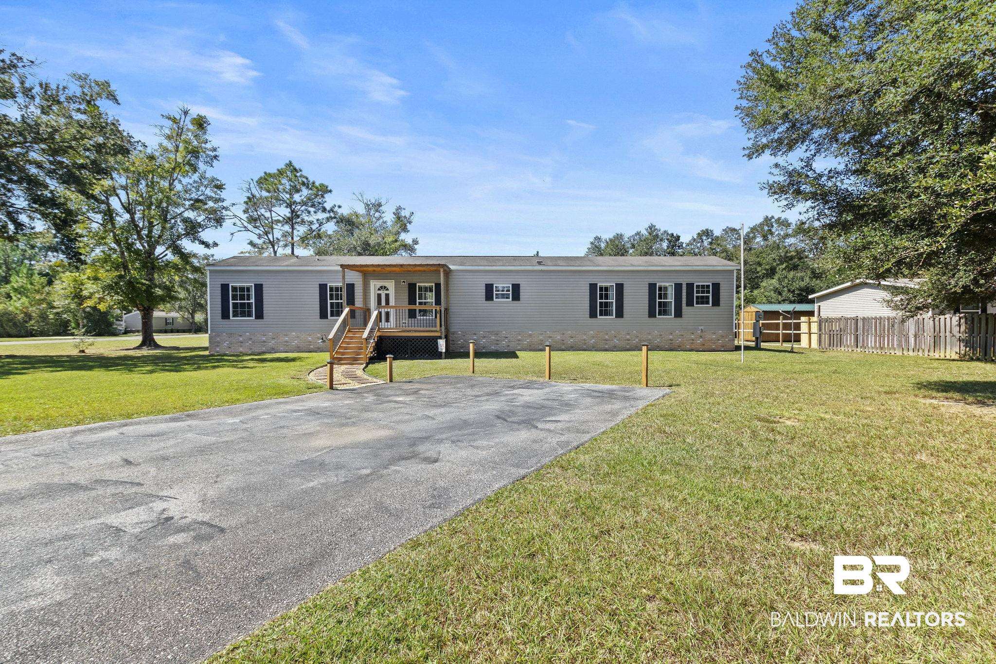 6870 Cecilia Court Theodore, AL 36582 - Photo 3 of 83 Back of property with a lawn and covered porch