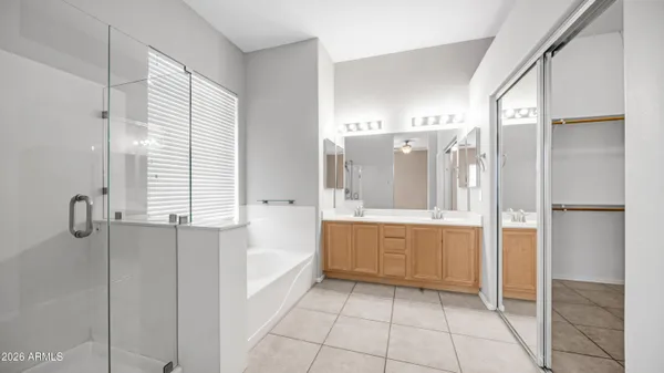 a bathroom with a bathtub shower and a sink
