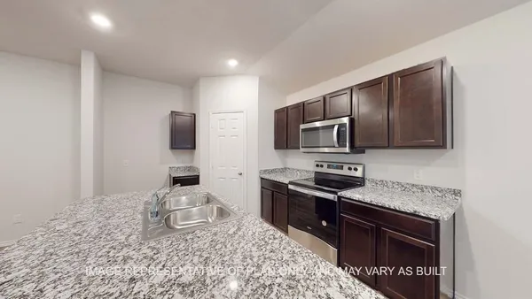 a kitchen with a sink stove and microwave