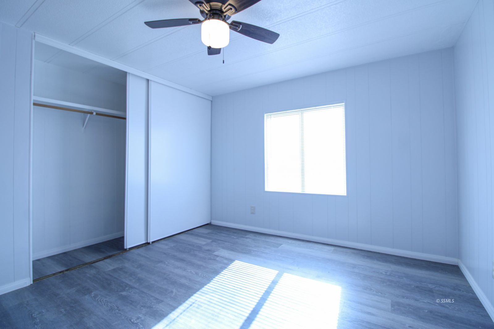 1441 West Iowa Avenue Ridgecrest, CA 93555 - Photo 13 of 27 an empty room with a window and a ceiling fan