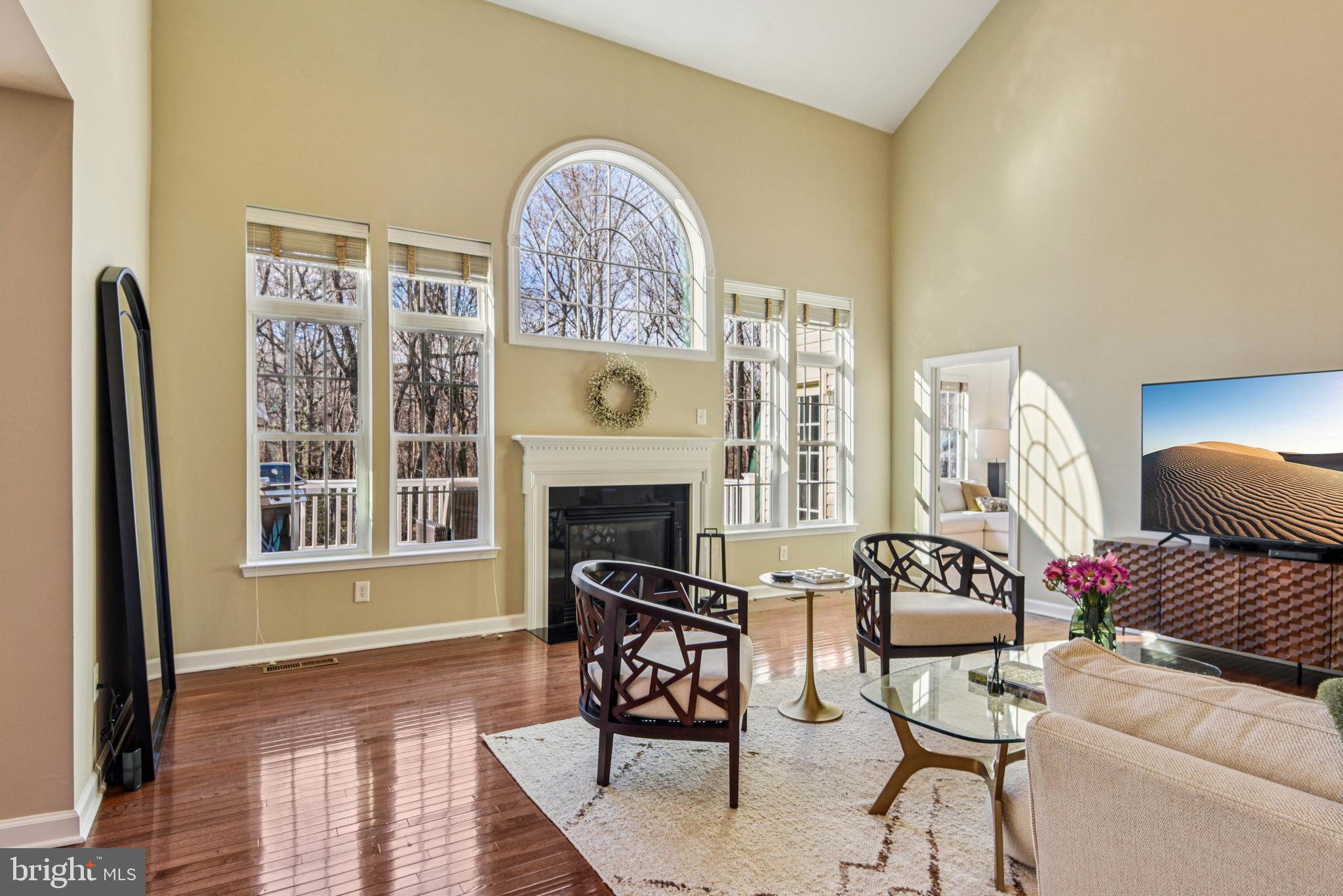 1705 Wolcott Way Hanover, MD 21076 - Photo 13 of 67 a living room with furniture a fireplace and a floor to ceiling window