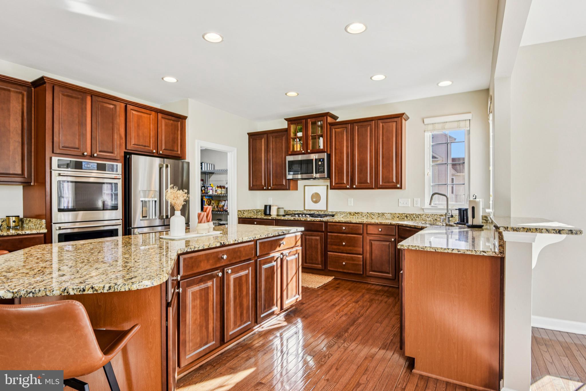 1705 Wolcott Way Hanover, MD 21076 - Photo 24 of 67 a kitchen with stainless steel appliances granite countertop sink stove refrigerator dining table and chairs