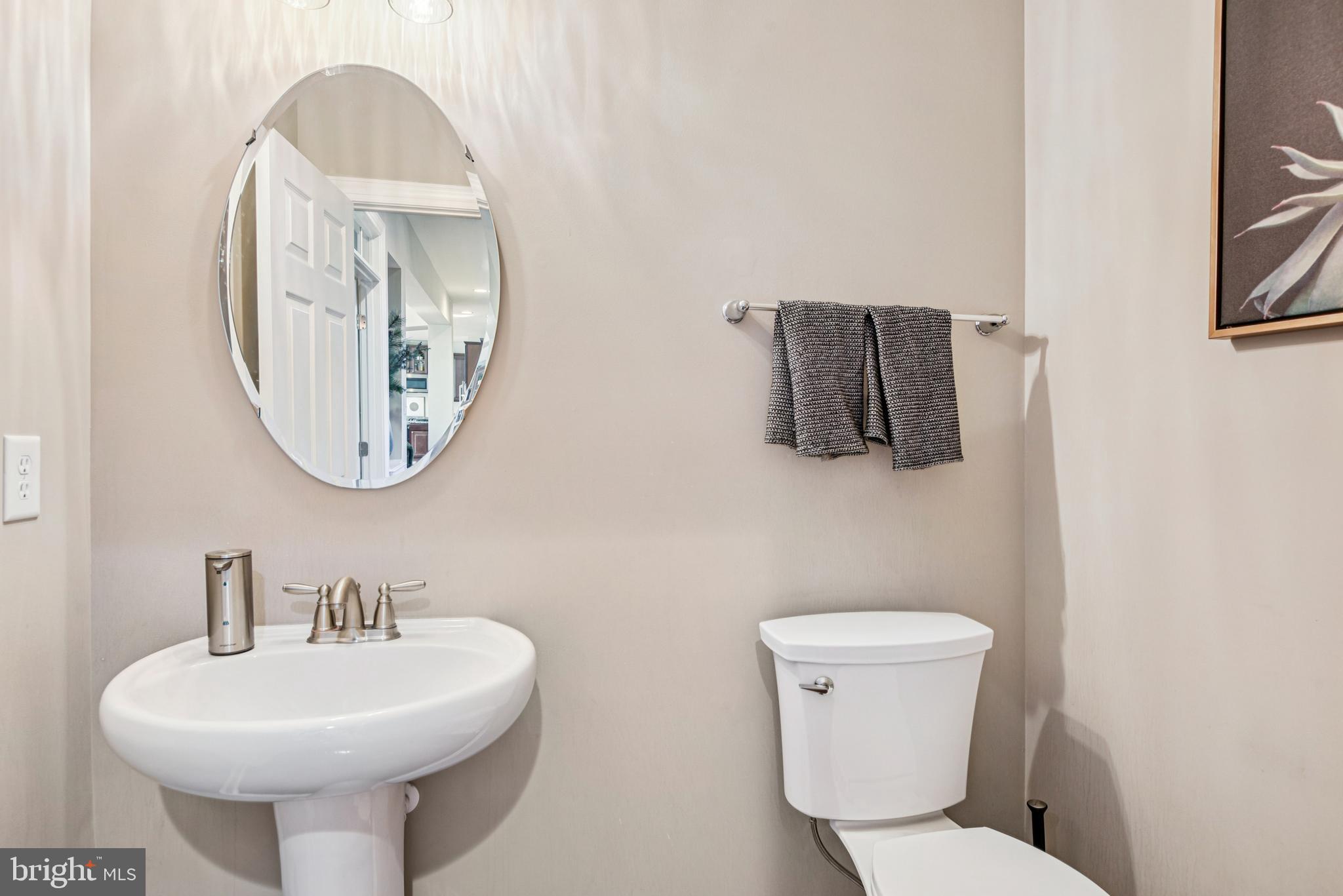 1705 Wolcott Way Hanover, MD 21076 - Photo 30 of 67 a bathroom with a toilet sink and mirror