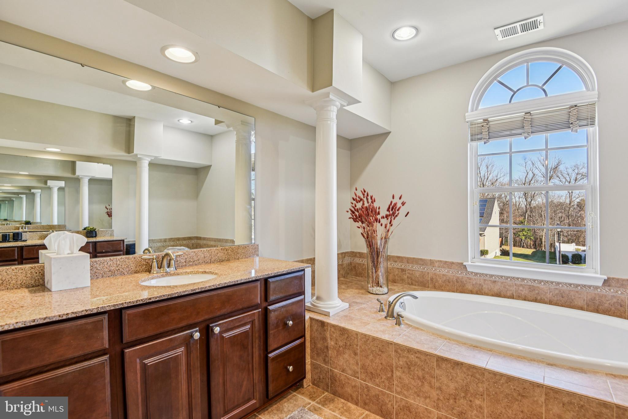 1705 Wolcott Way Hanover, MD 21076 - Photo 41 of 67 a spacious bathroom with a granite countertop tub sink and mirror
