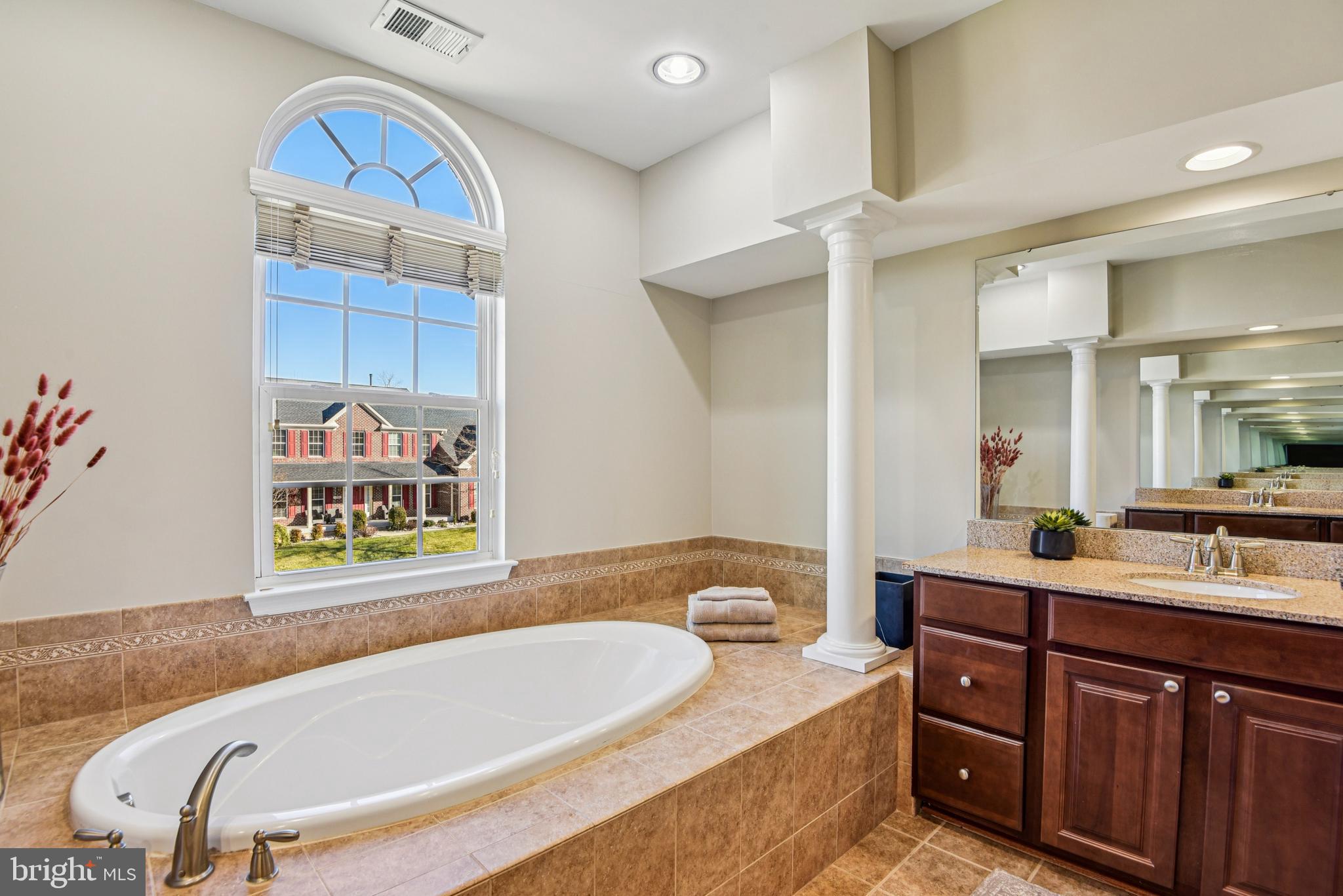 1705 Wolcott Way Hanover, MD 21076 - Photo 42 of 67 a bathroom with a tub sink and mirror